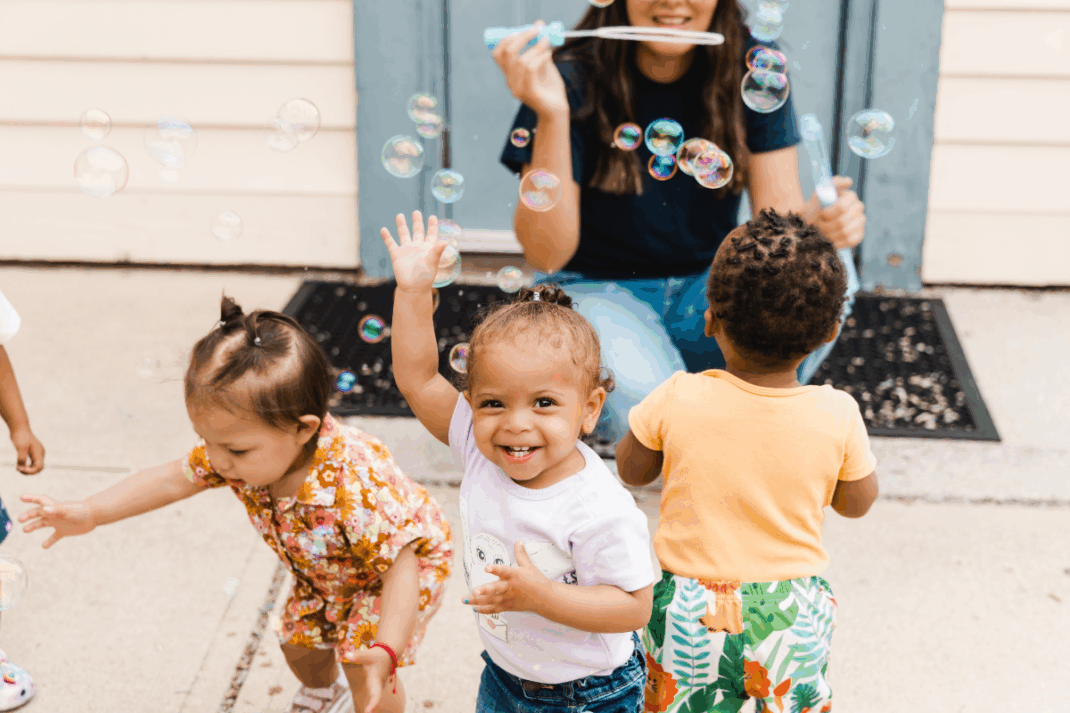 Children playing and blowing bubbles.